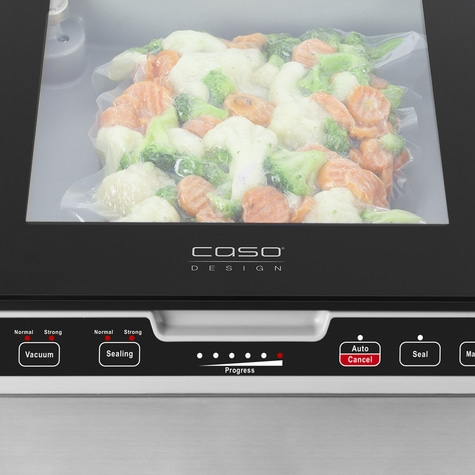 Vacuum sealer with vegetables in a plastic bag, control panel with buttons and indicators