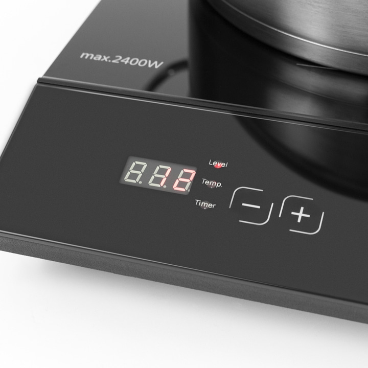 Induction cooktop with digital display and controls for temperature and timer settings.