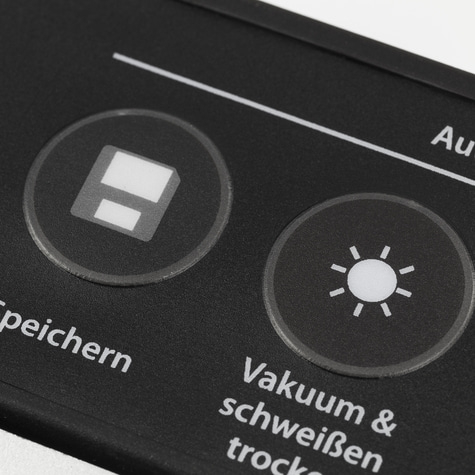 Schwarzes Bedienfeld mit Symbolen und Text, Vakuum und Schweißen.