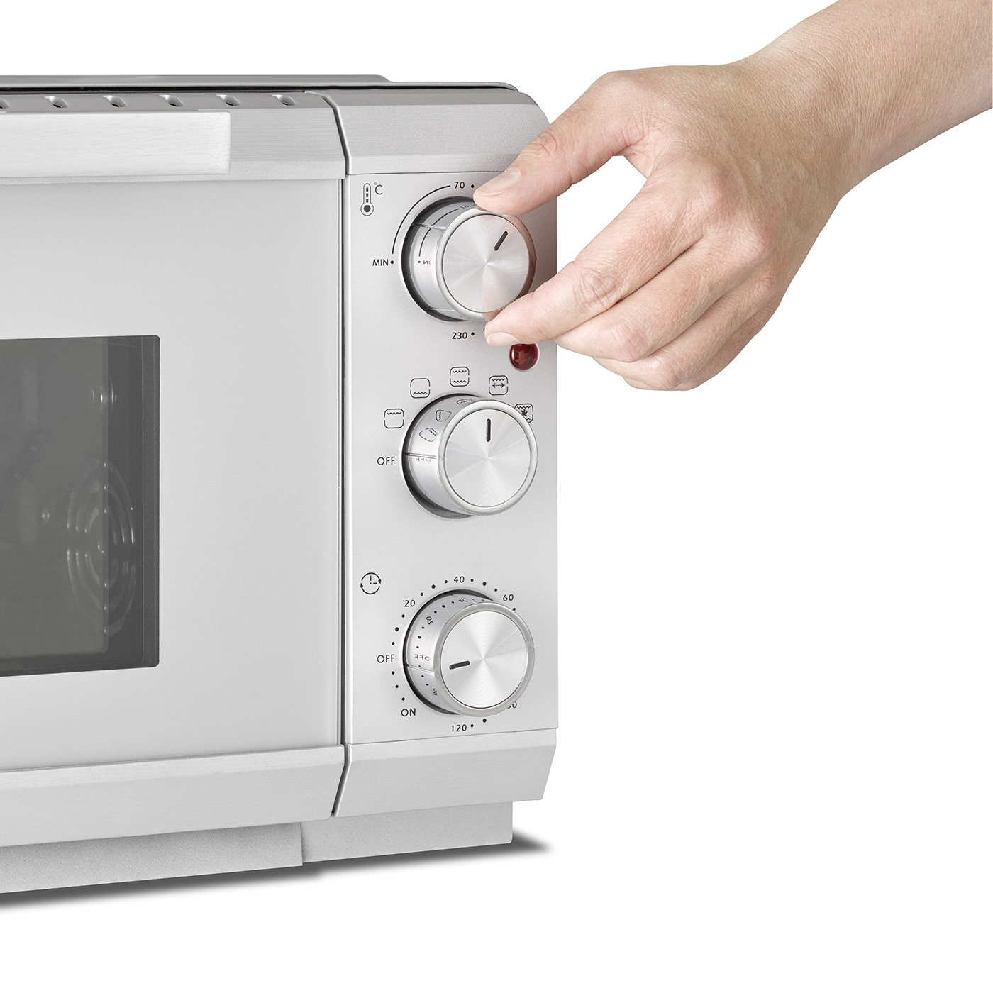 Ofen mit Knöpfen, Hand dreht Temperaturregler, Temperaturanzeige, Zeitregler, silbernes Gehäuse