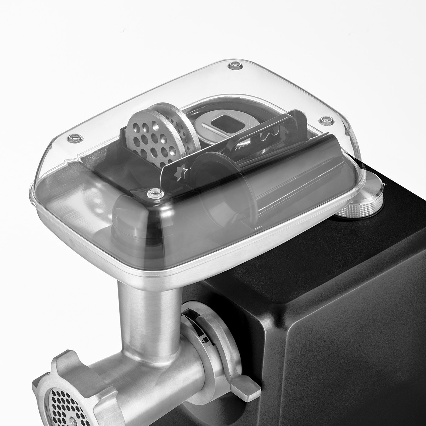 Meat grinder with transparent cover and accessories, close-up, black and silver