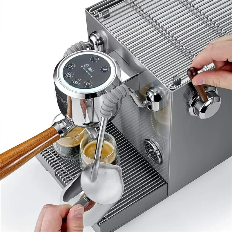 An espresso machine brews two cups of coffee with a wooden handle portafilter.