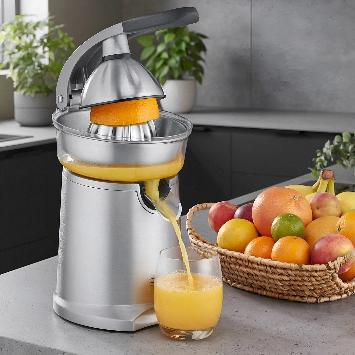 A juicer with oranges and a fruit basket in a modern kitchen.