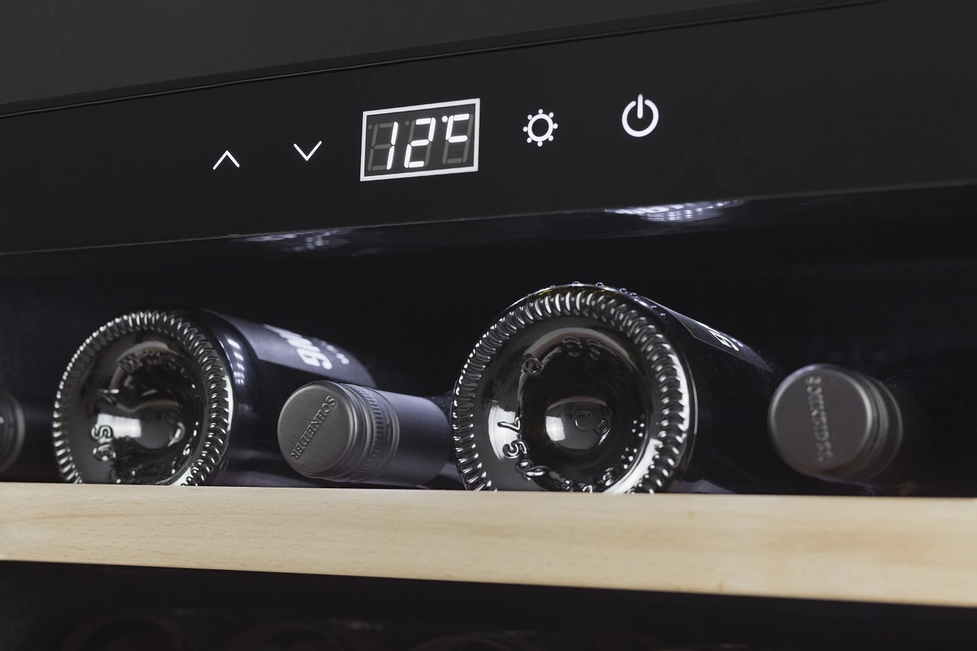 Wine cooler with temperature display and wine bottles inside the fridge.