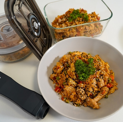 Fried rice with chicken and vegetables in a bowl and glass container.