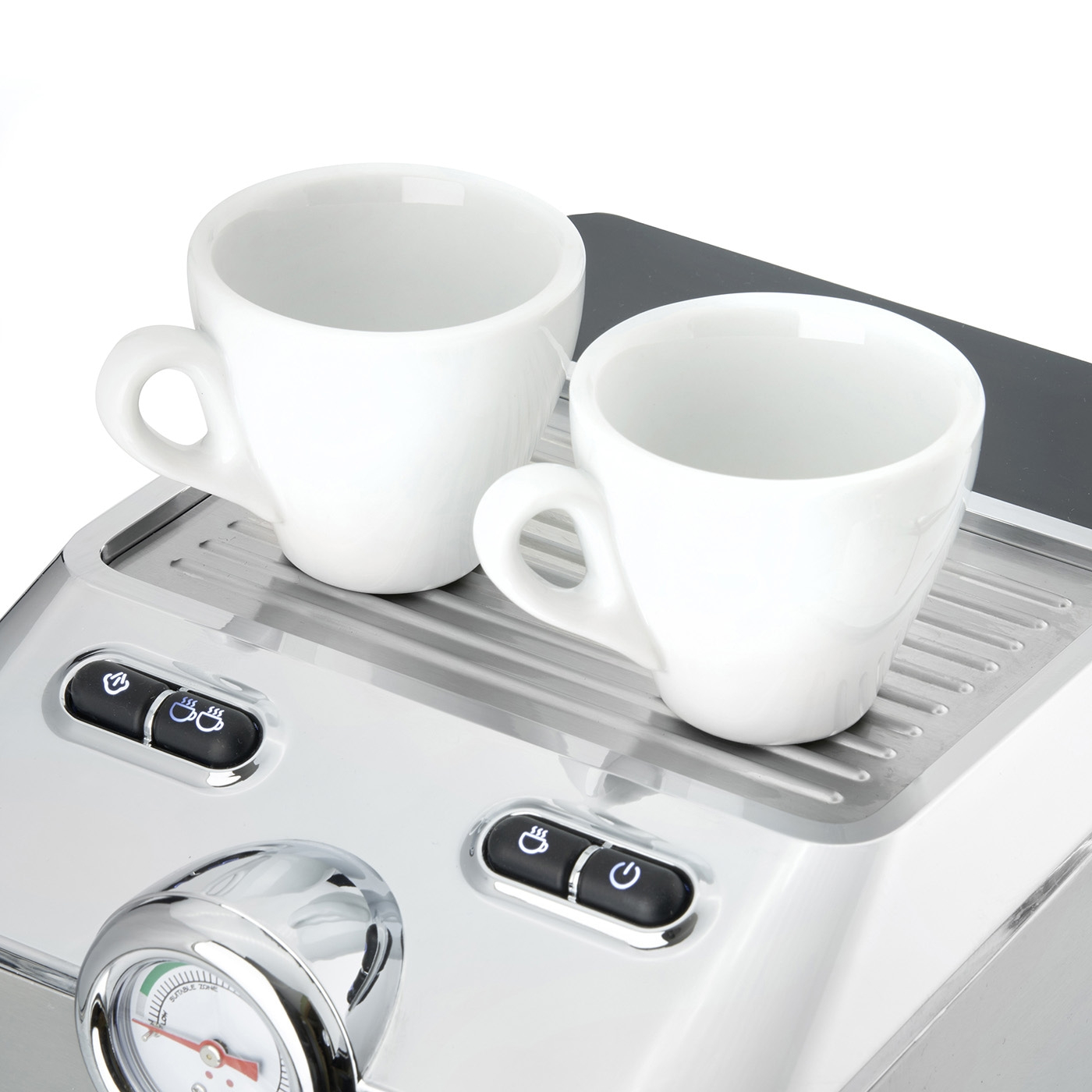 Two white cups on an espresso machine with buttons and a gauge, close-up.