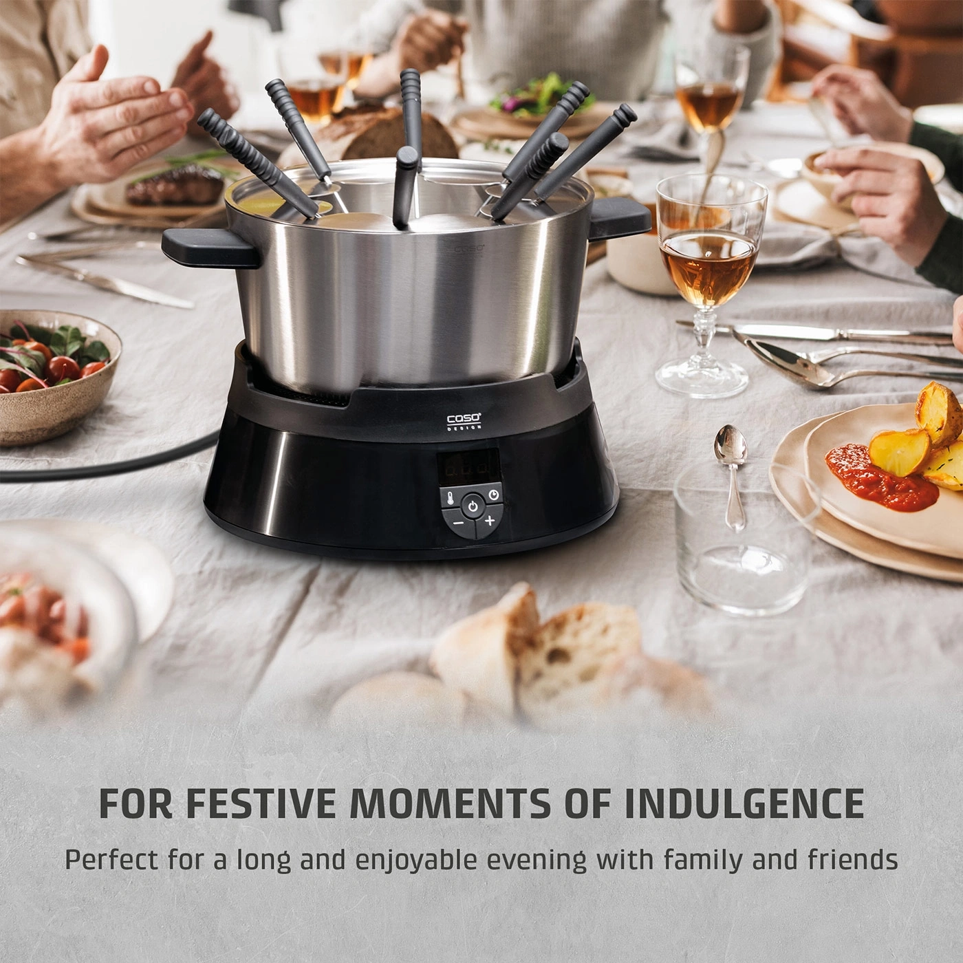 A fondue set on a table with food and people dining.