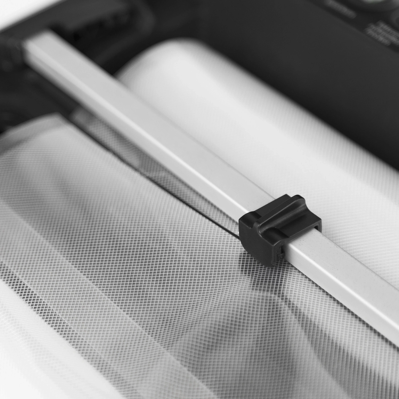 Close-up of white mesh fabric and a black plastic component