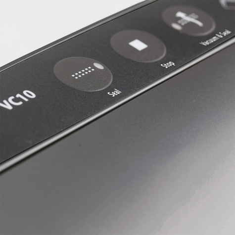 Close-up of control panel with 'Seal', 'Stop', and 'Vacuum & Seal' functions.