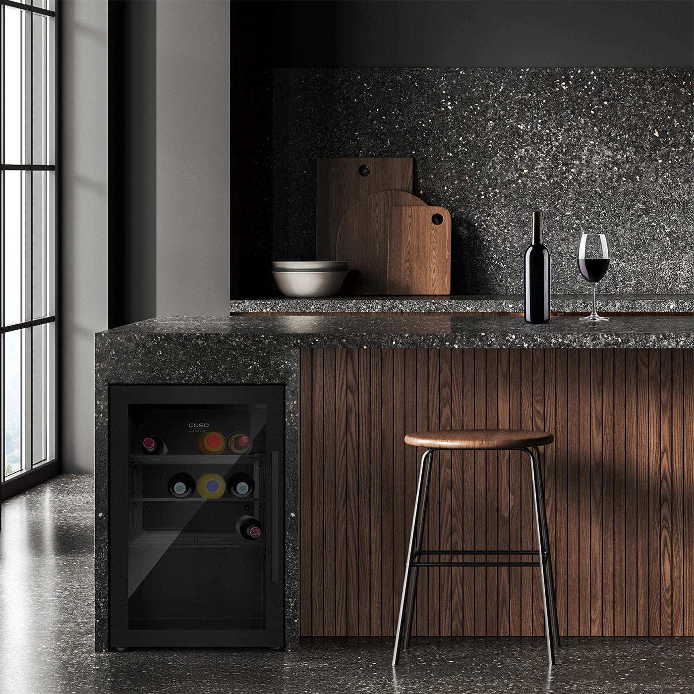 Wine cooler, bar stool, wine bottle and glass on a countertop in a kitchen.