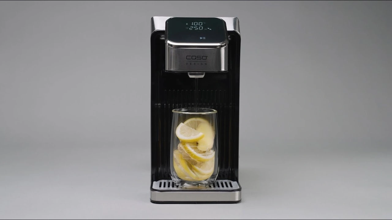 A water dispenser with a glass of lemons on a gray background.