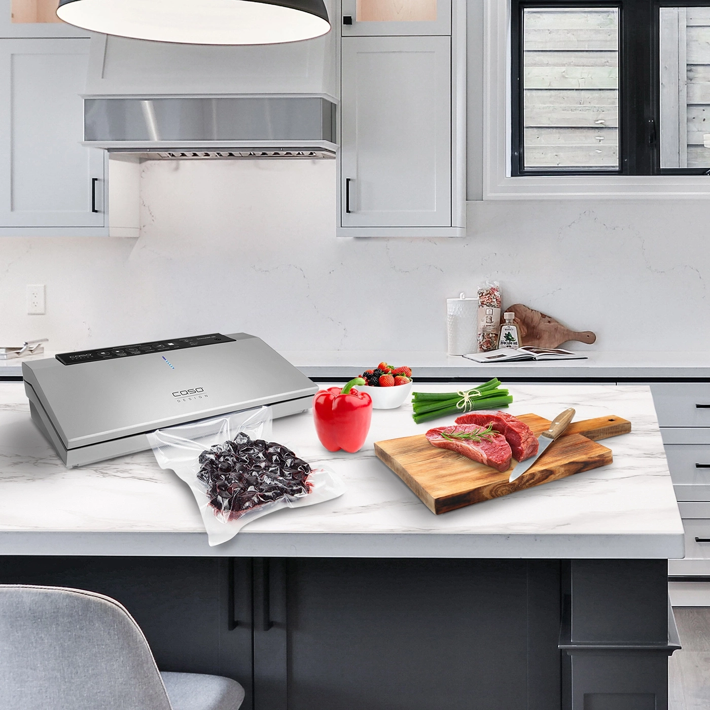 Kitchen with vacuum sealer, meat, vegetables and fruits on the countertop.
