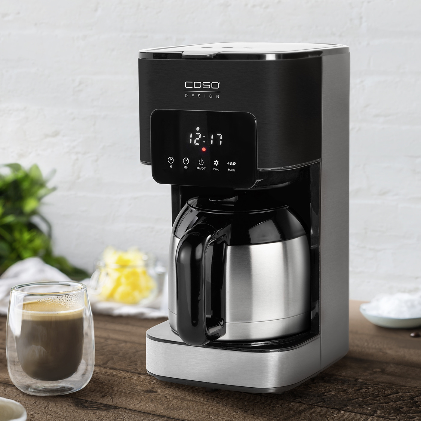Coffee machine with digital display and coffee cup on a wooden table
