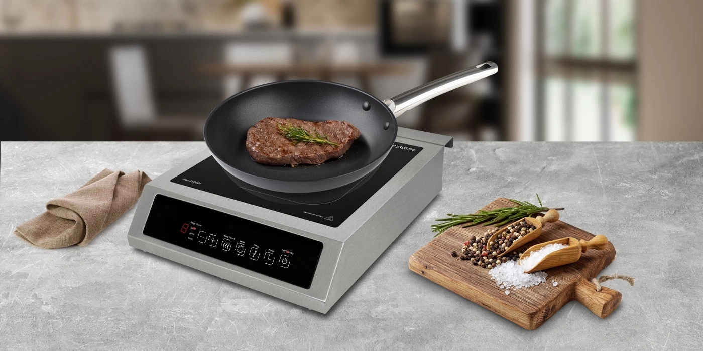 Steak in pan on induction cooktop with spices on wooden board