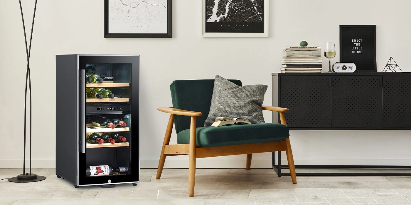 A modern room featuring a wine cooler, an armchair, and a cabinet.