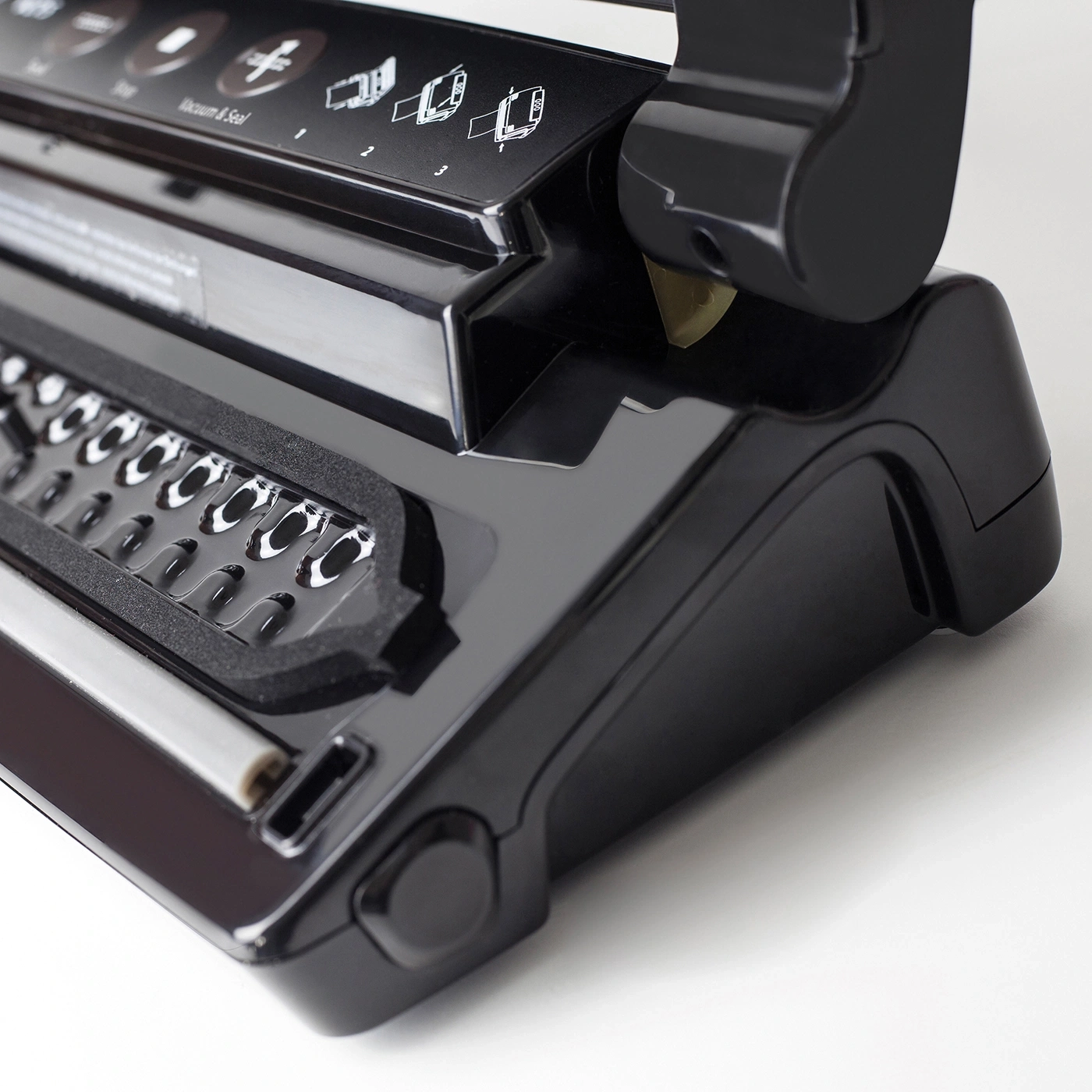 Black vacuum sealer with control panel and vacuum and seal function.