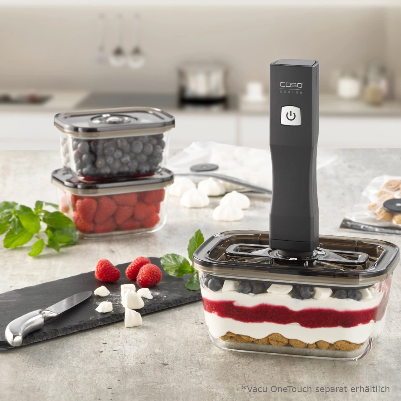 Image of berries, a knife, and a vacuum sealer in a glass container.