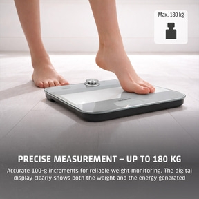 A person steps onto a scale with the text Max. 180 kg.