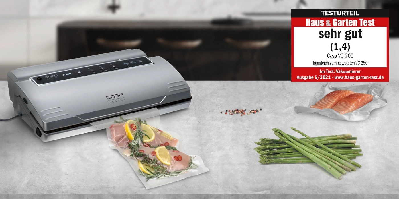 Vacuum sealer with 'very good' test result and food like salmon and asparagus.