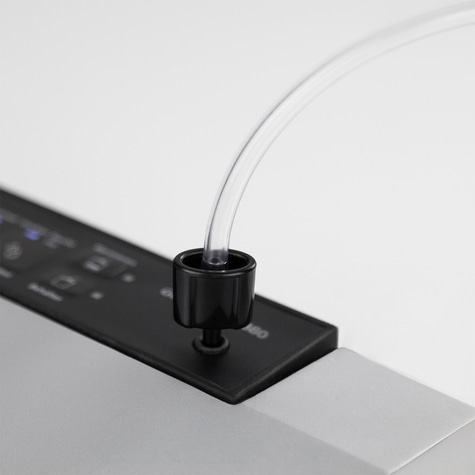 Close-up of a black device with a clear tube inserted into it, on a white background.