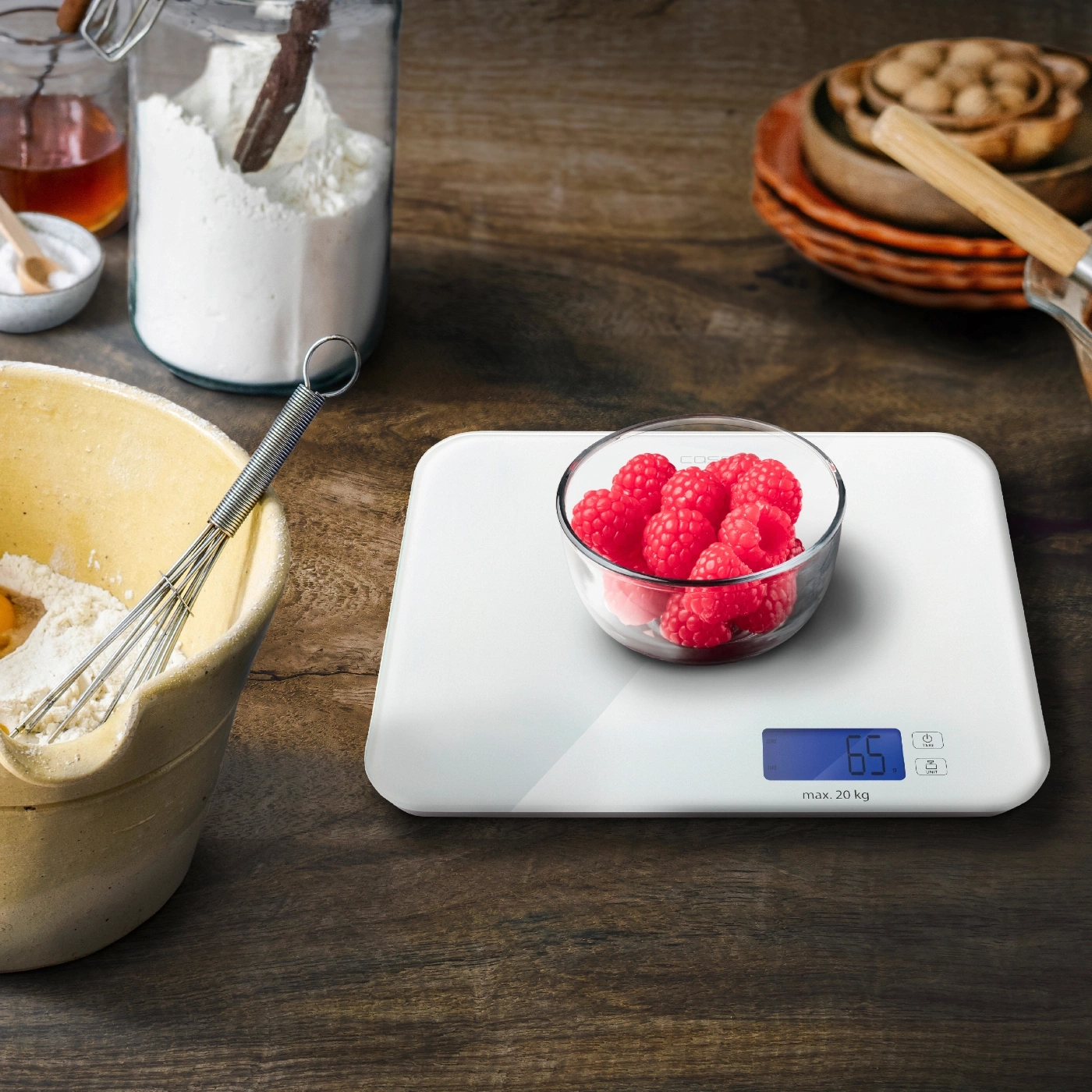 Raspberries on a scale, baking ingredients, kitchen, wooden surface, close-up shot