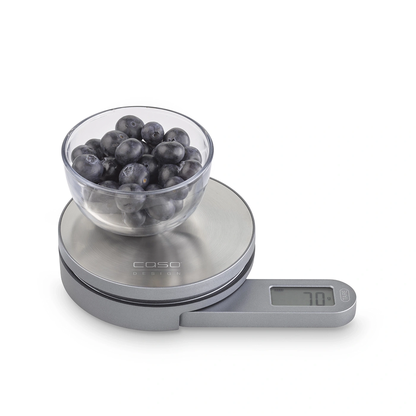 Blueberries in glass bowl on digital kitchen scale, weight 70g