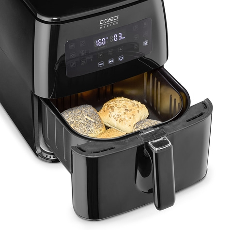 Black air fryer with rolls, control panel, pulled out basket, close-up, kitchen appliance