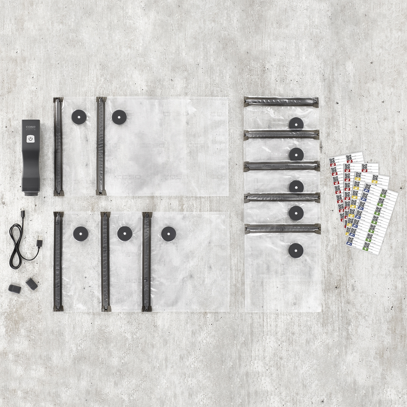 Vacuum sealer set with bags and labels on gray background. Food packaging.