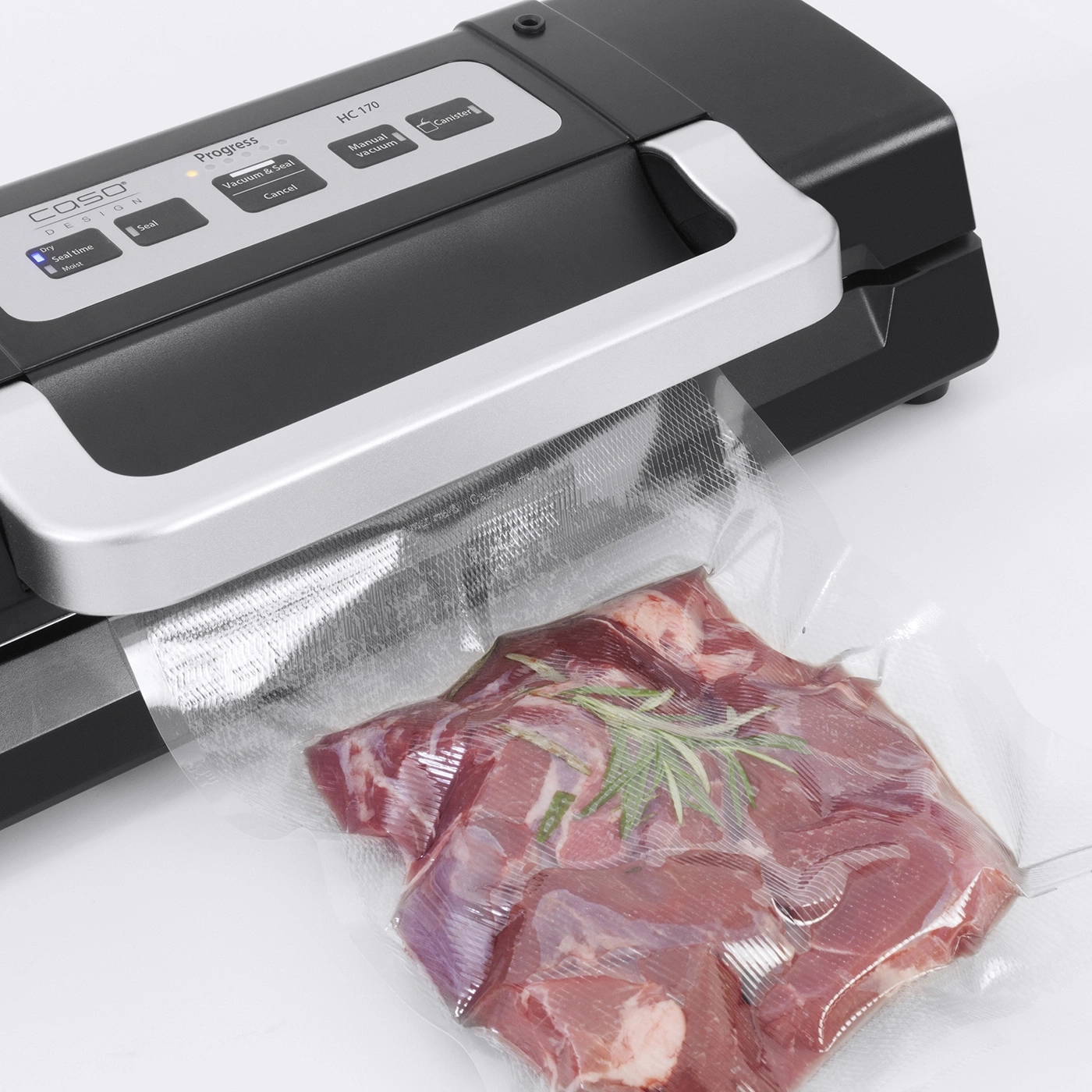 Vacuum sealer with meat in a bag, ready to seal. Caso Design. HC 170.