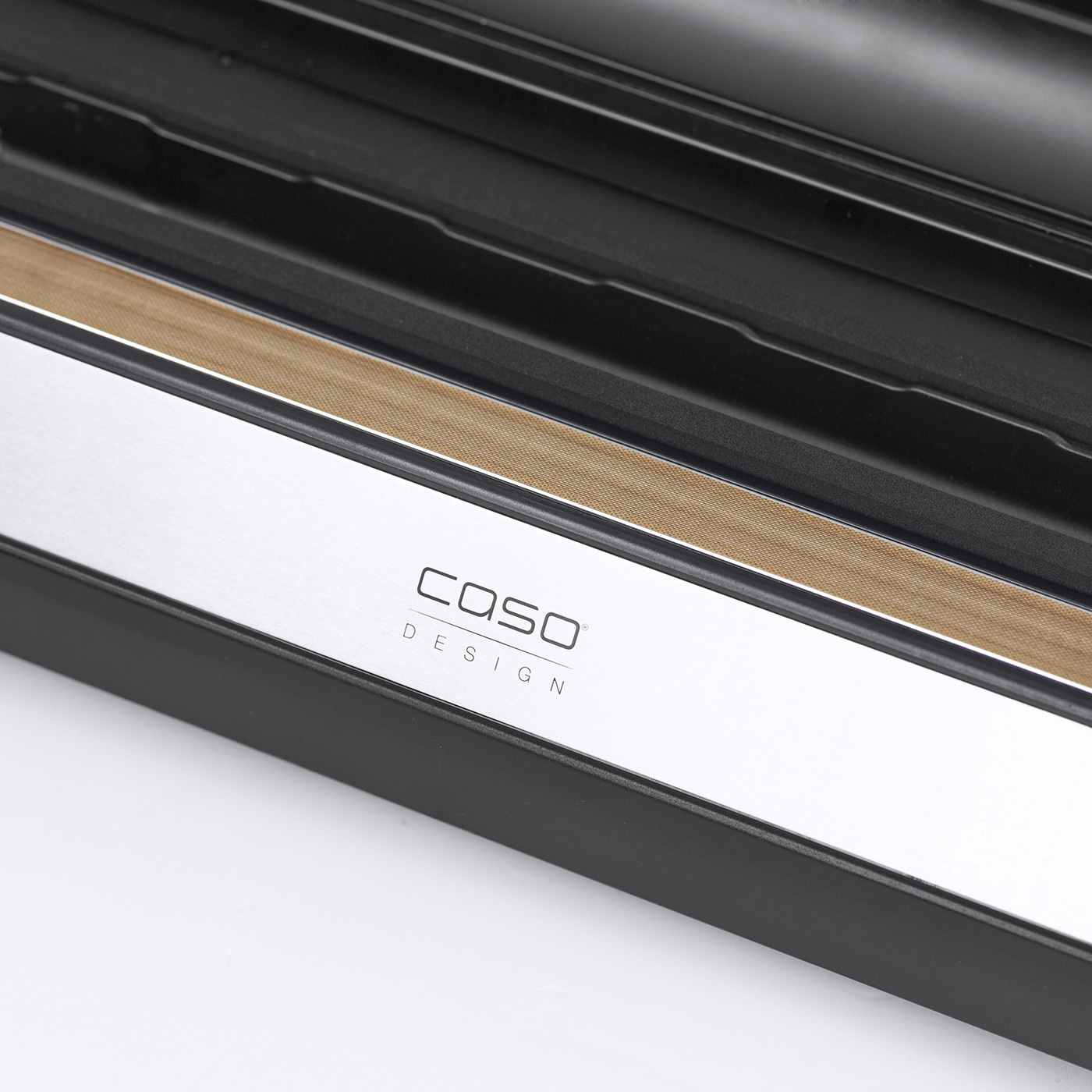 Close-up of a Caso design vacuum sealer with wood and metal accents