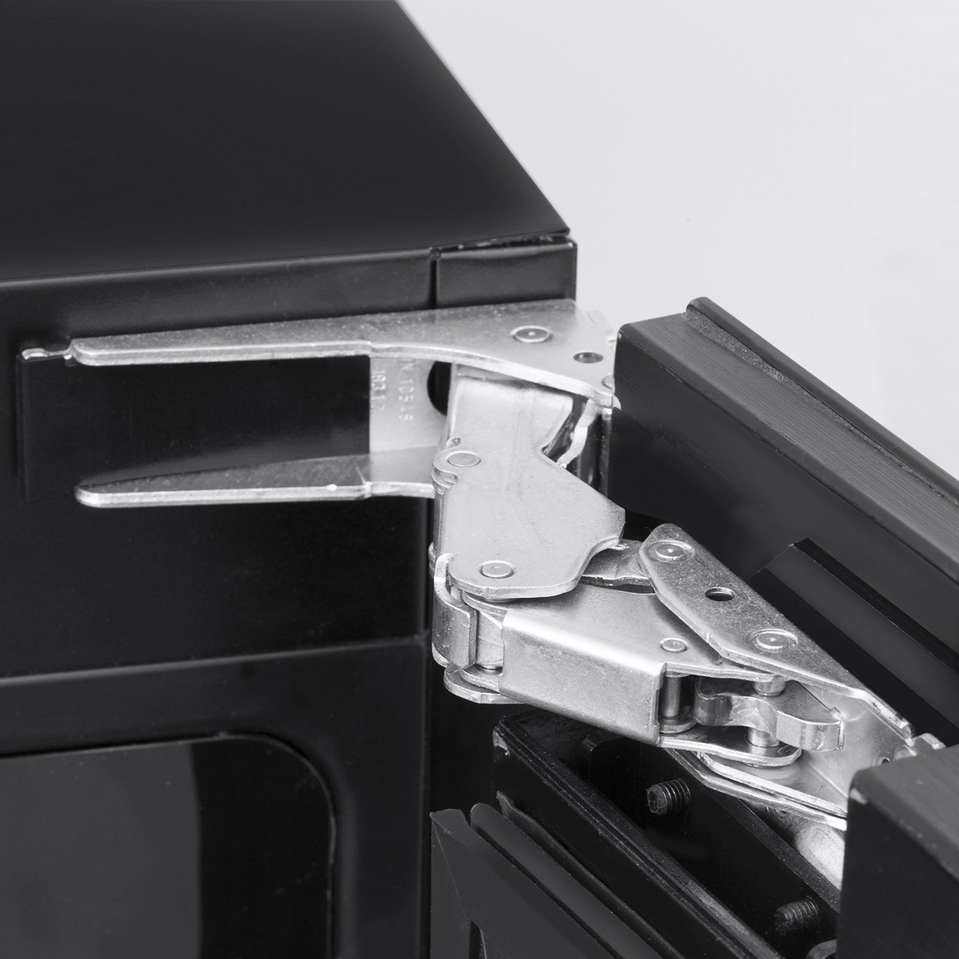 Black cabinet with silver hinge attachment, close-up, detail shot, metal