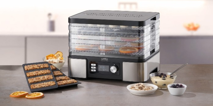Food dehydrator with fruits and snacks on a table
