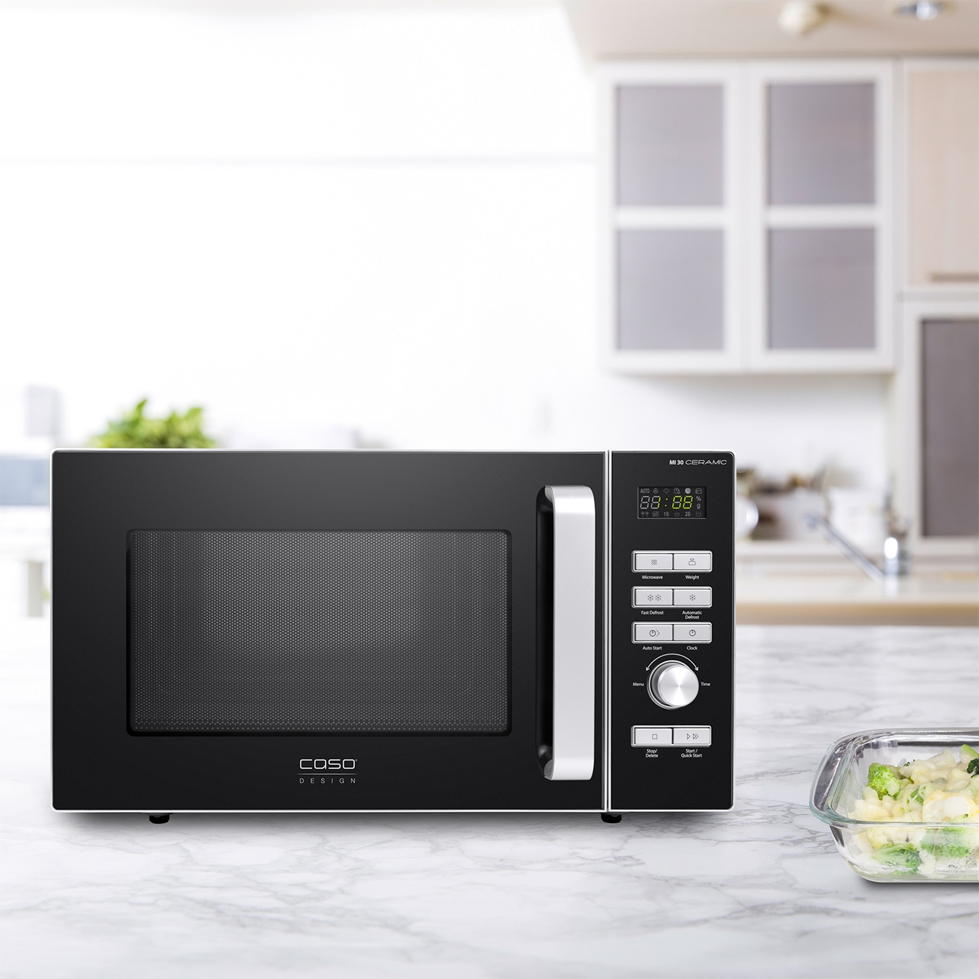 Black microwave with control panel and display on a kitchen countertop.