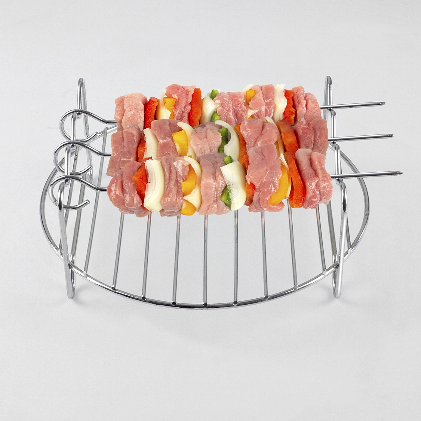 Skewers on a grill, ready to grill, with vegetables and meat, food preparation