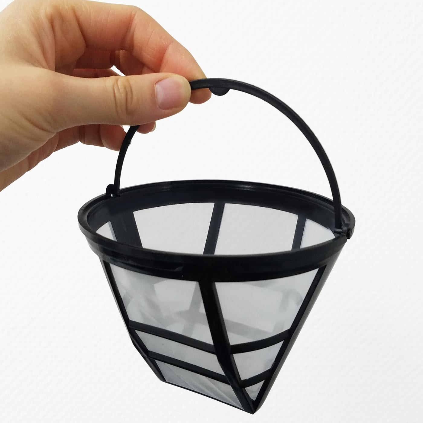 Coffee filter with handle held by hand against a white background