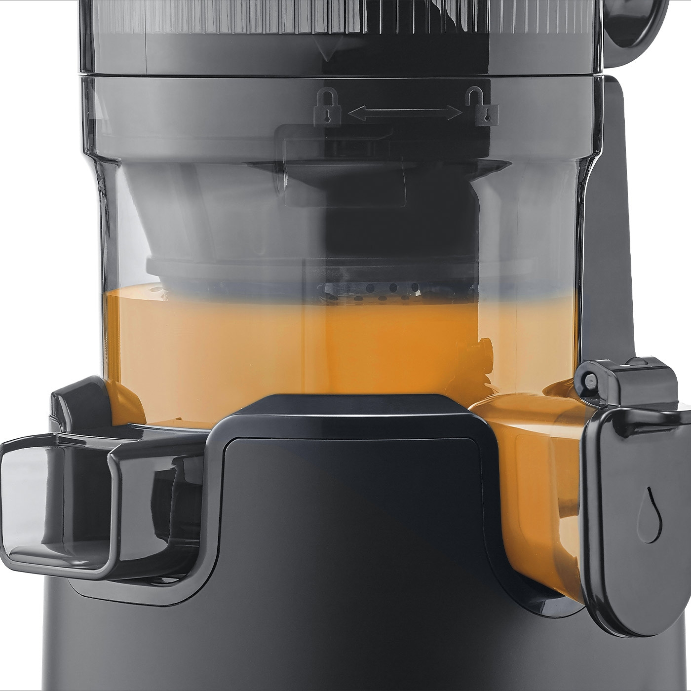 Close-up of a black juicer with juice. Orange juice in the container.