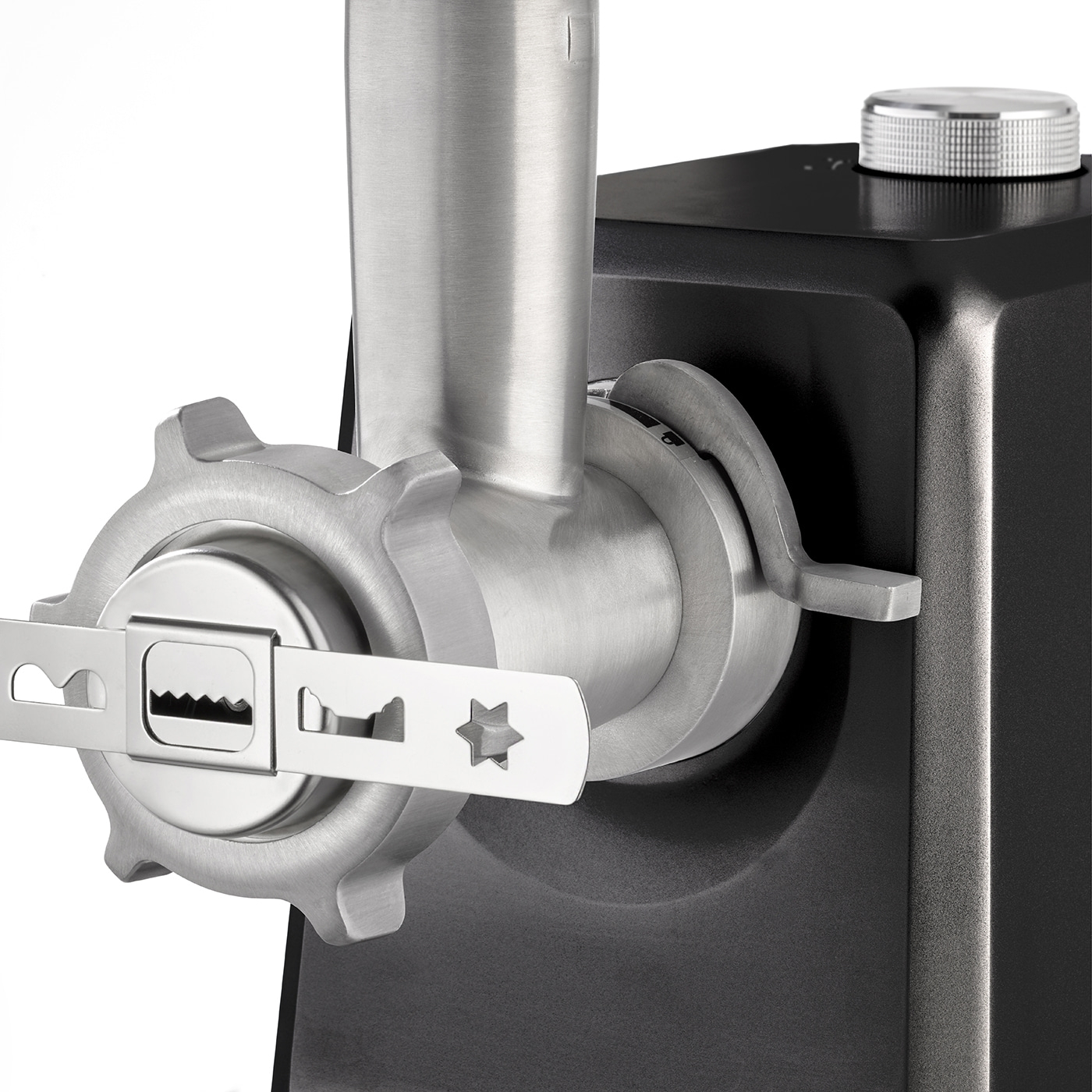 Close-up of a meat grinder with metal parts and a black housing.