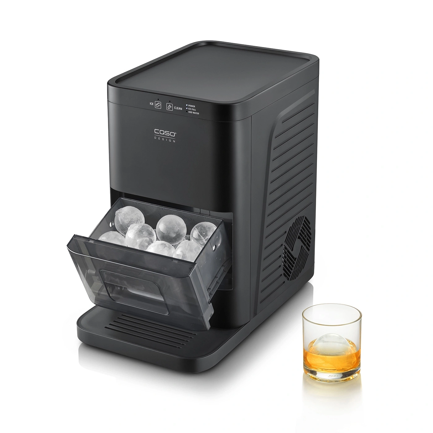 A black ice maker with ice balls and a glass of whiskey next to it.