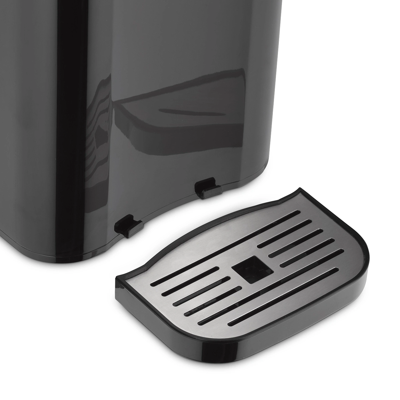 Close-up of a black coffee machine with a removable drip tray, isolated