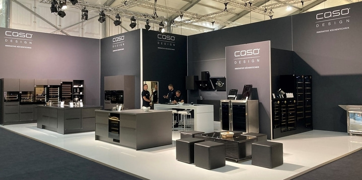 Kitchen exhibition with modern appliances and the 'Caso Design' logo.