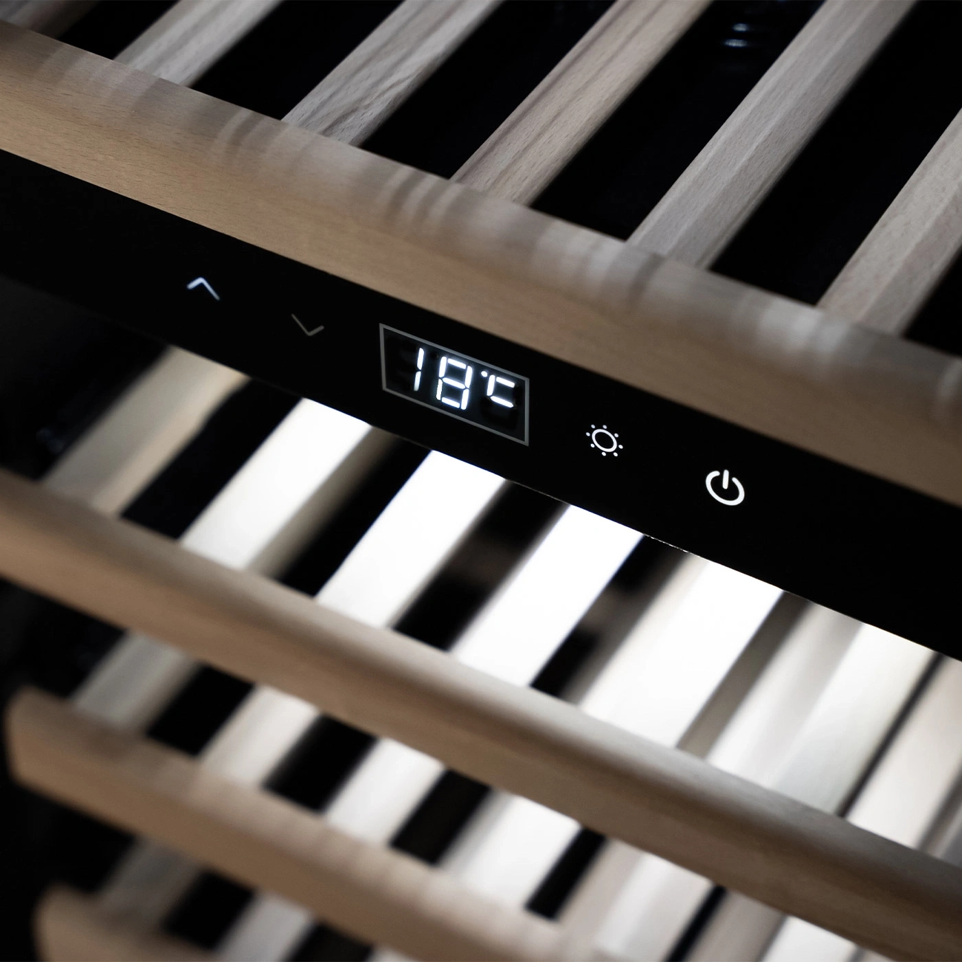 Wine cooler with temperature display and control panel, wooden shelves in the foreground