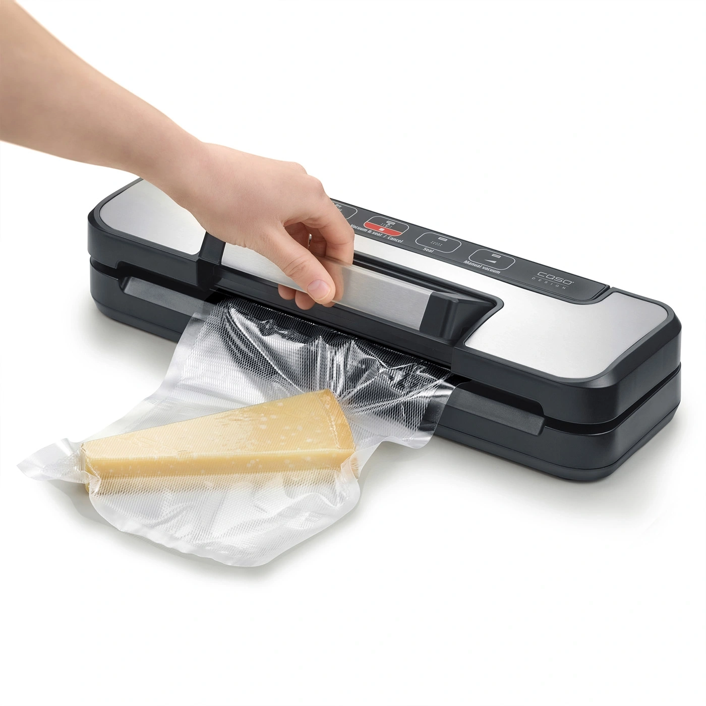 A block of cheese is placed in a vacuum sealer to be sealed.