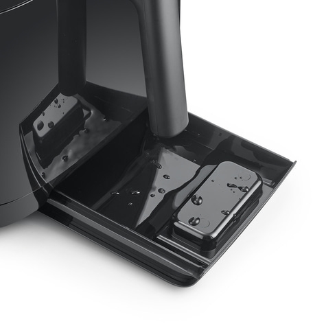 Black machine with water. Close-up shot. Drops on the surface. Shiny surface.