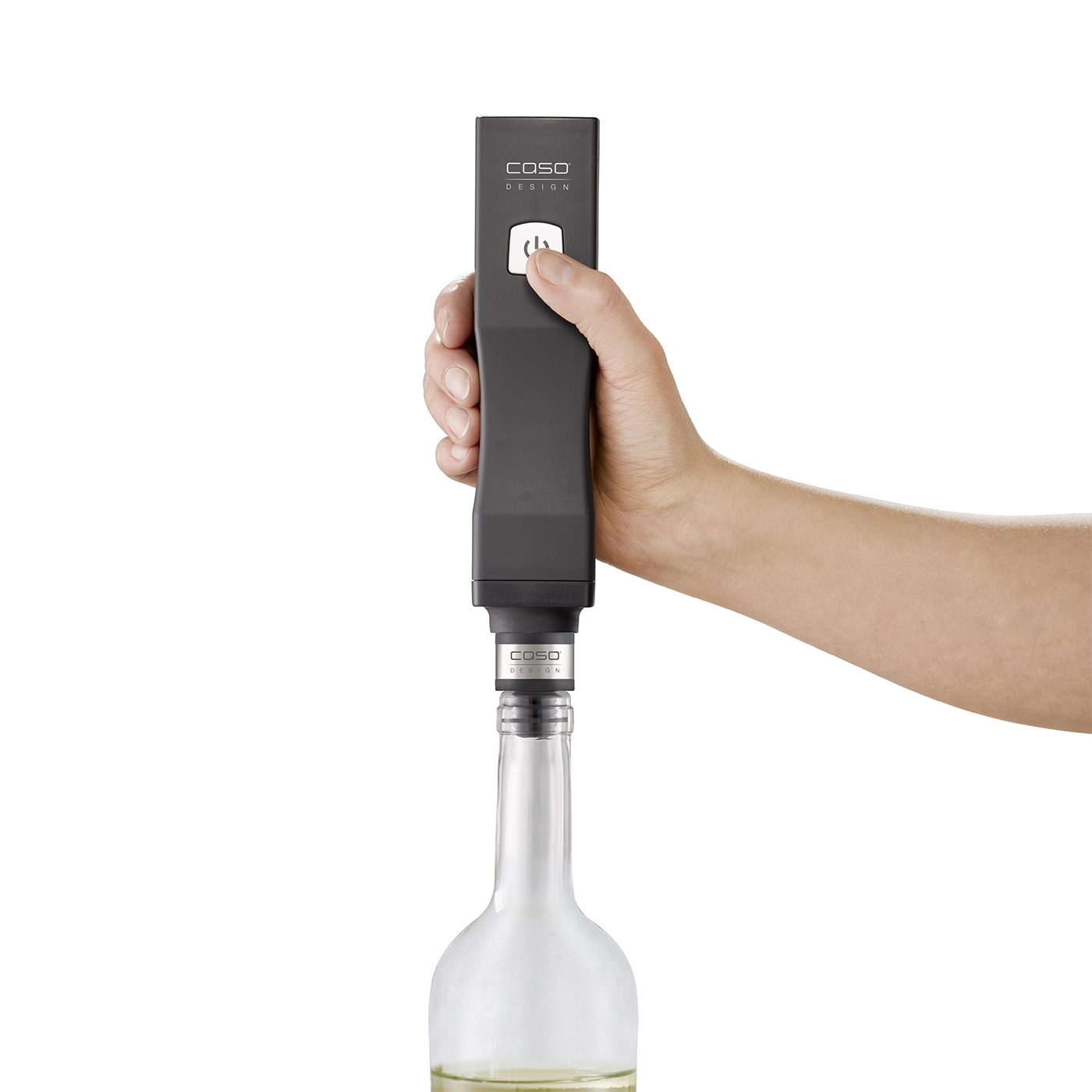Person holding a black device over a wine bottle. Caso Design.