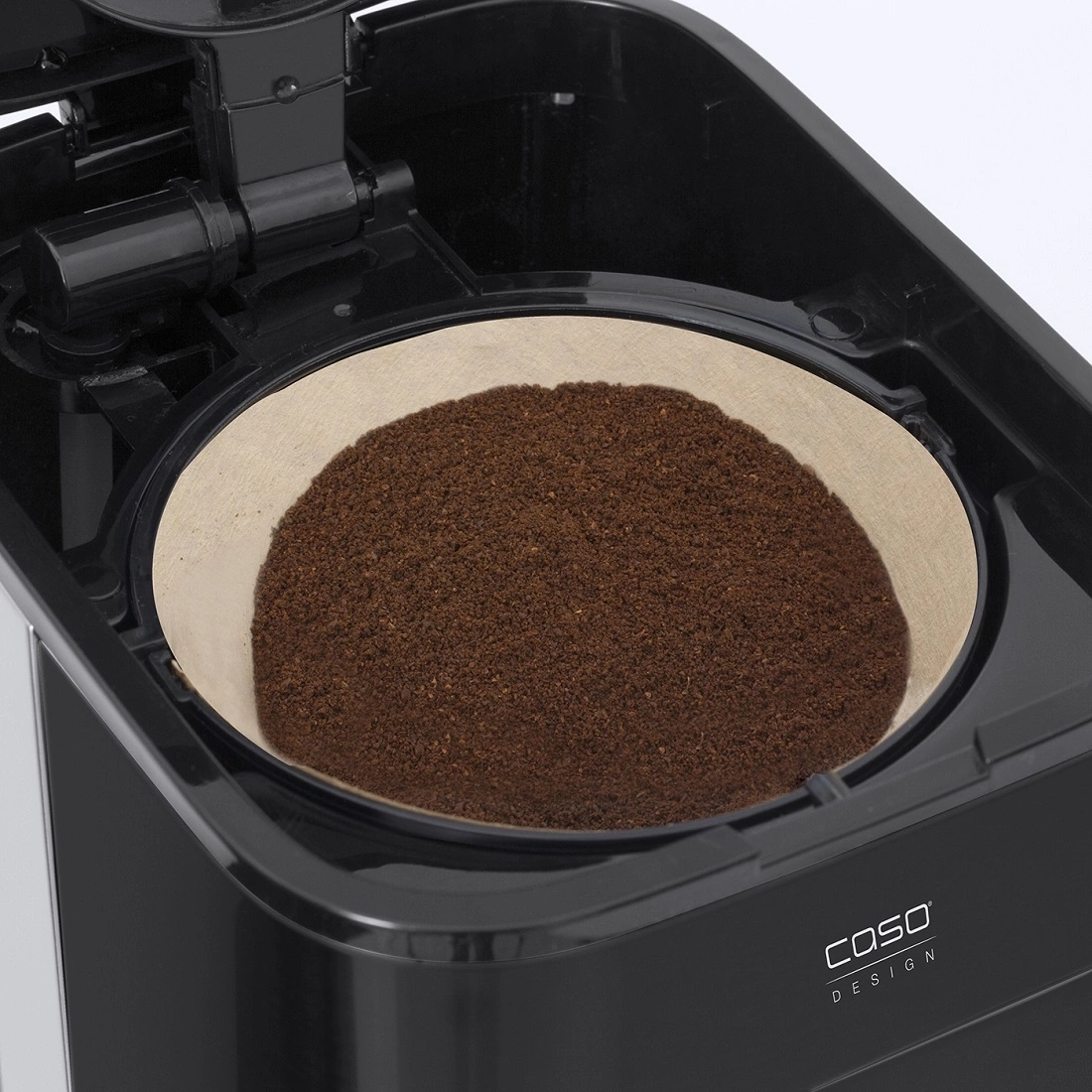 Coffee machine with coffee filter and coffee grounds, close-up, black, Caso Design.