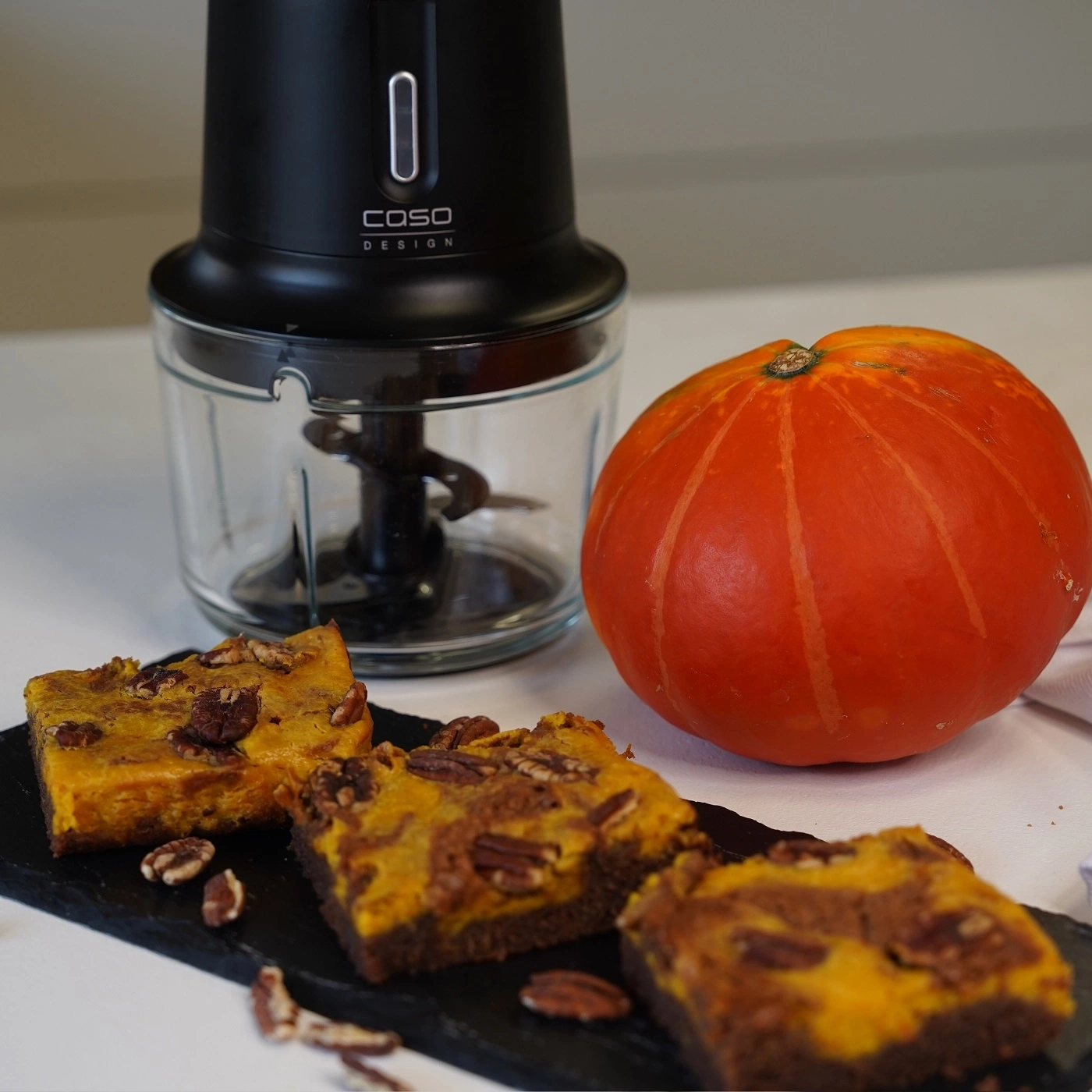 Pumpkin, cake, and food processor. Autumnal food preparation and cooking.